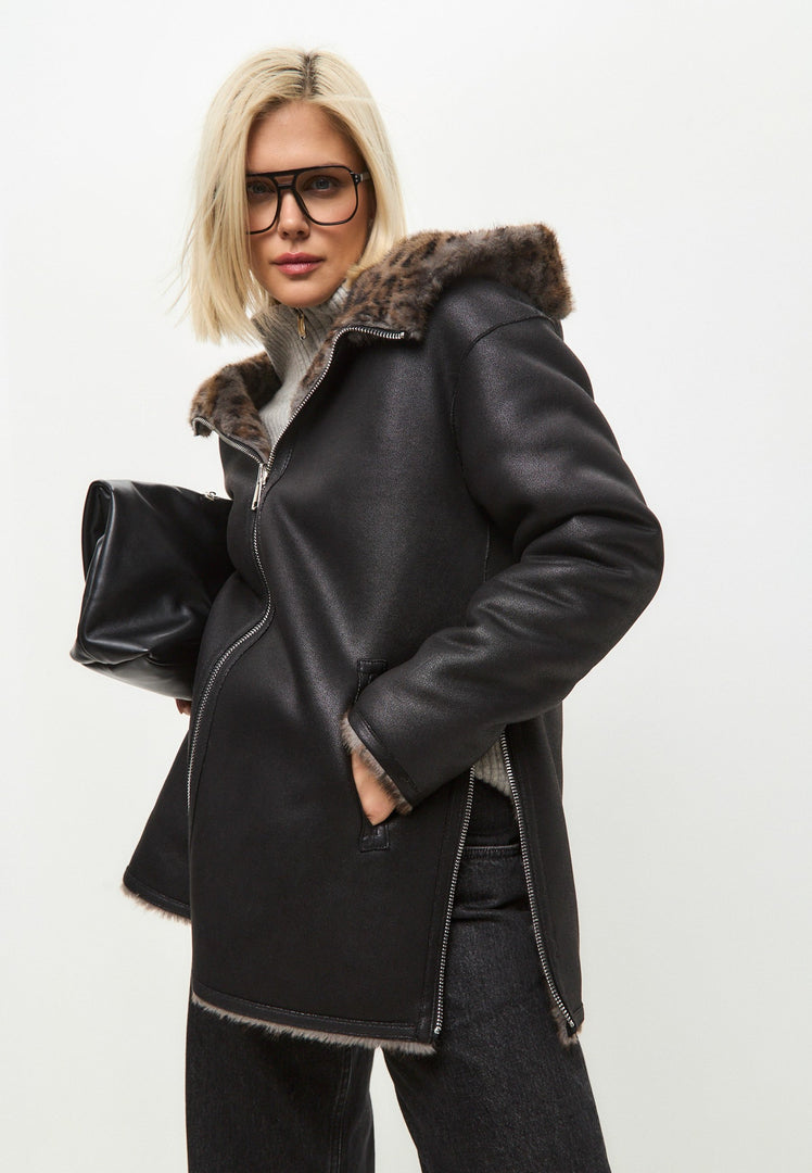 A stylish women's winter jacket with a reversible design, featuring leopard faux fur trim and animal print details on faux leather material.