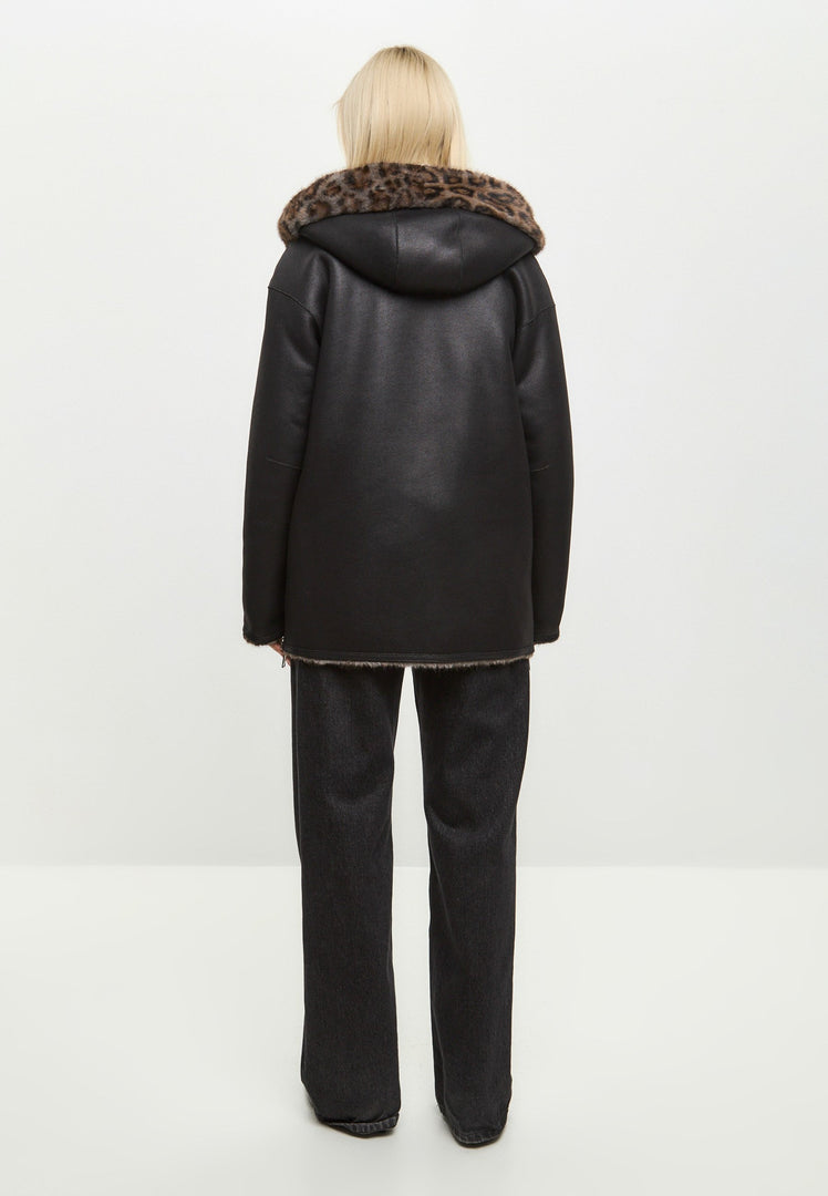 A stylish women's winter jacket in faux leather with leopard faux fur trim, offering a reversible design for versatile wear.