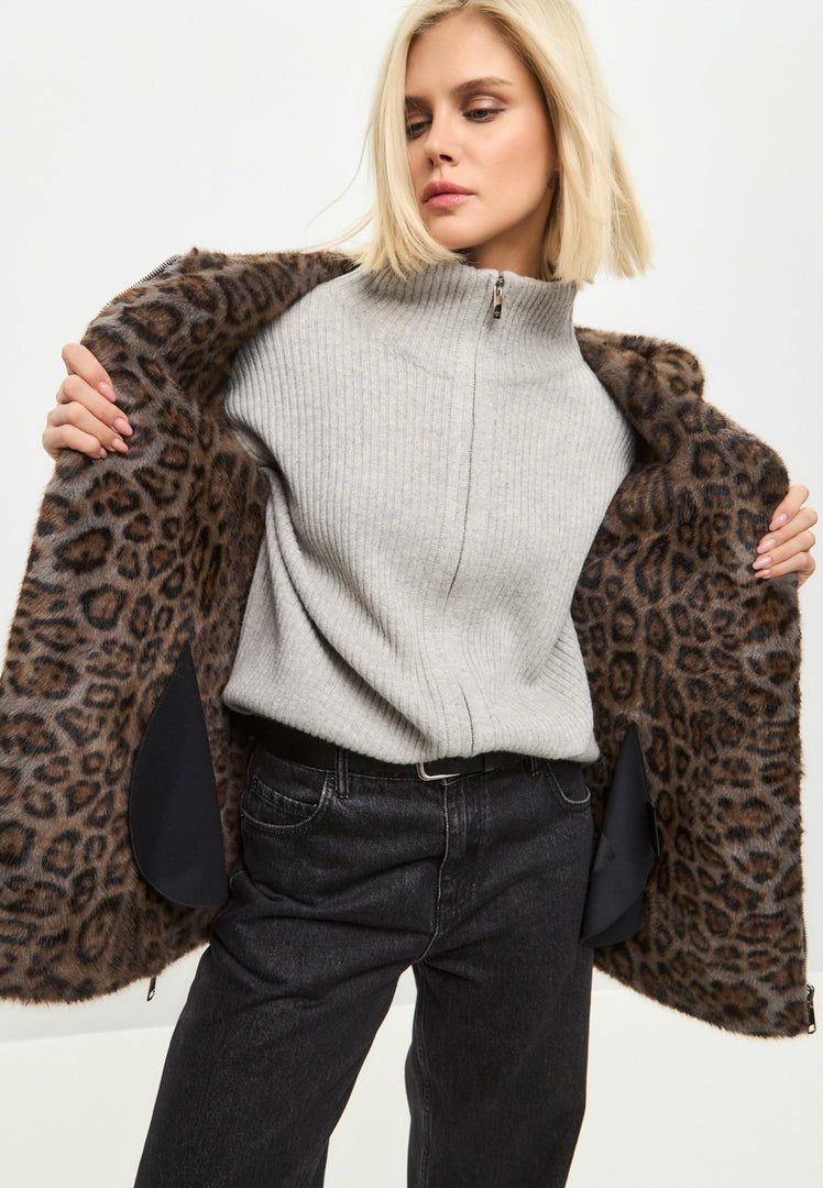 A stylish reversible faux leather jacket with trendy leopard faux fur trim, perfect for staying warm and fashionable in the winter.