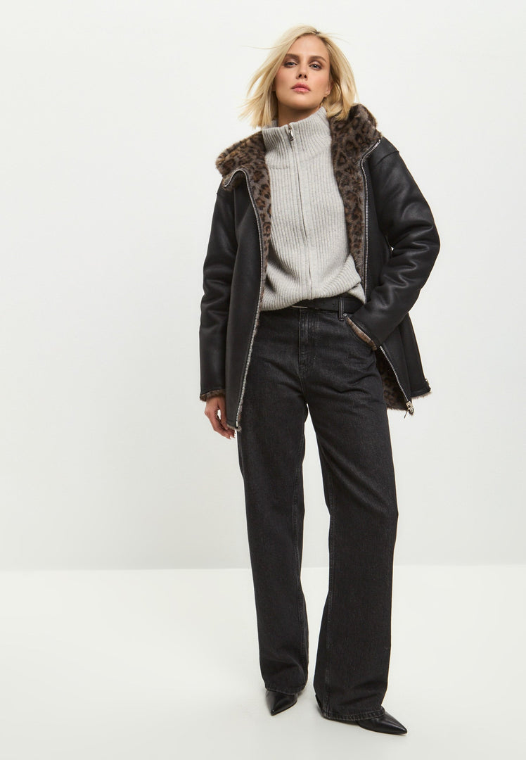 A stylish women's winter jacket featuring a reversible faux leather design with leopard faux fur trim, perfect for adding a touch of animal print to your outfit.