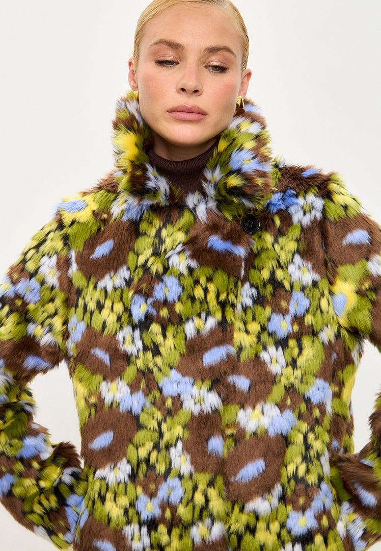 A fashionable long faux fur coat with a trendy floral print design, perfect for a bold and vibrant look.