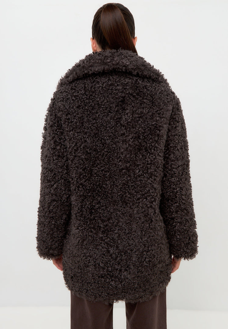 A stylish and cozy black shearling Eva coat, perfect for staying warm and fashionable in the cold weather.
