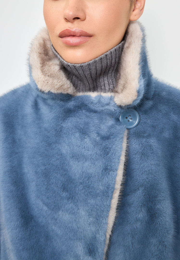A stylish blue faux fur coat with crystal embellishments, perfect for a glamorous winter fashion look.