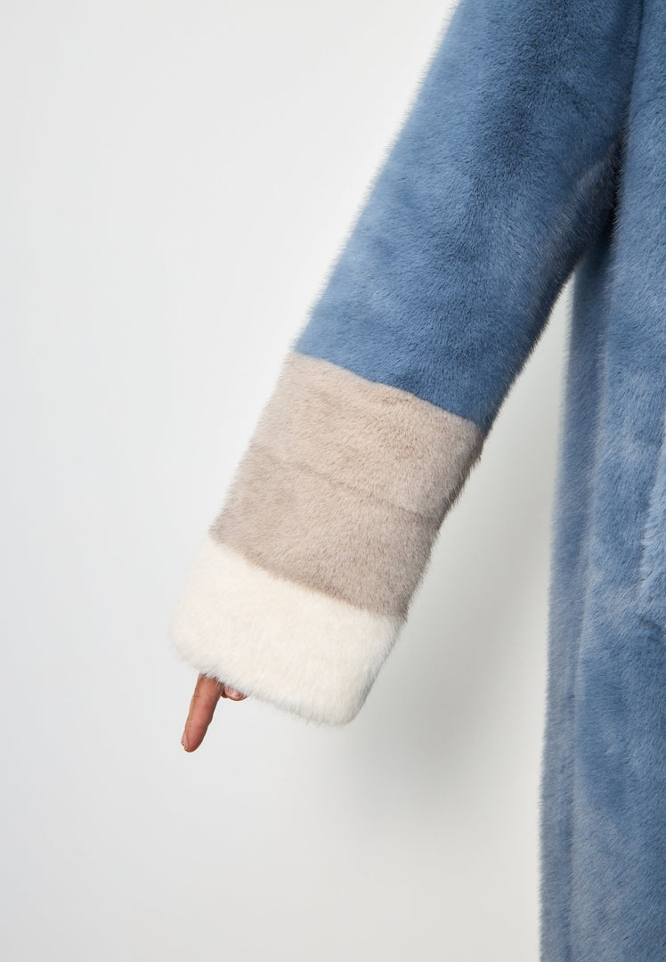 An elegant blue faux fur coat with crystal embellishments, perfect for winter fashion.