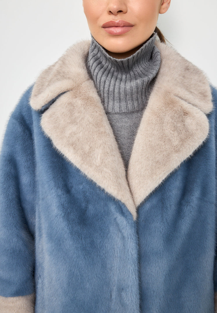 A sophisticated blue faux fur coat with crystal embellishments, the perfect addition to your winter fashion wardrobe.