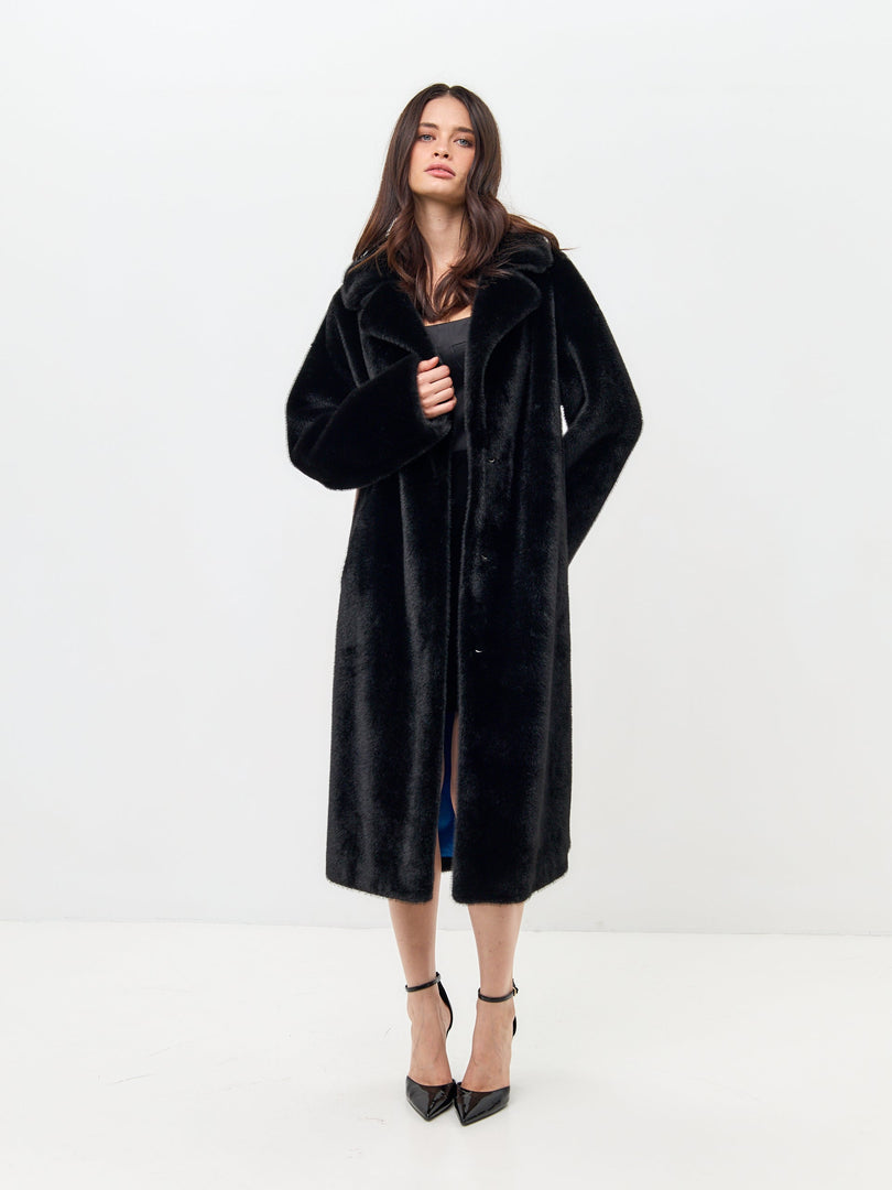 Two fashionable people strolling in the city, showcasing their love for deluxe long black coats with unique prints - an ideal choice for black coat lovers and deluxe coat lovers alike.
