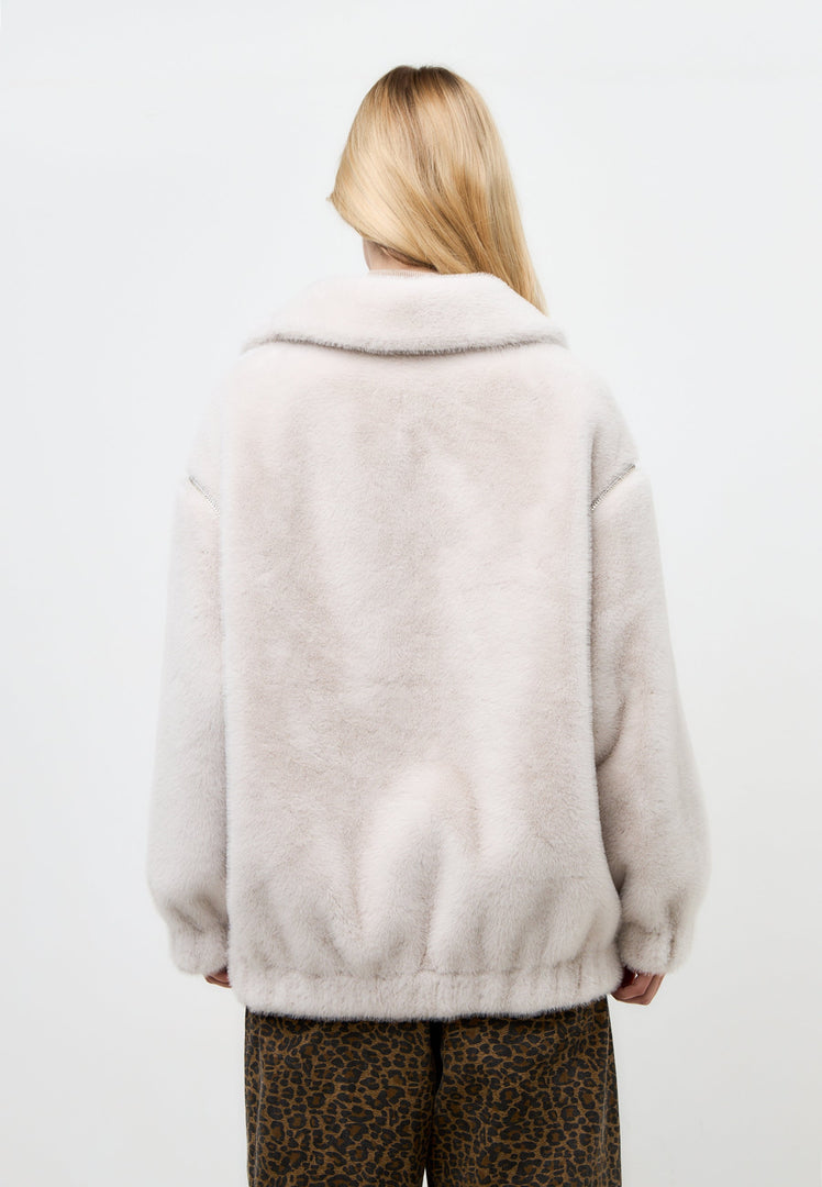 A stylish white faux fur short coat inspired by Marilyn Monroe's iconic style, perfect for winter fashion.