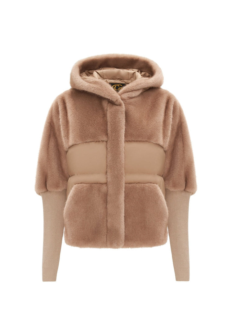 A stylish woman wearing a beige oversized faux fur jacket, a must-have piece for winter outerwear fashion trends for women.