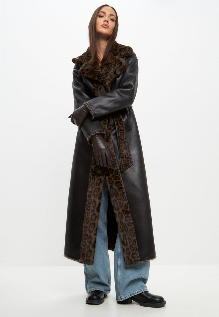 A stylish woman wearing a reversible faux fur coat, a long winter coat perfect for cold weather, showcasing the versatility and elegance of faux fur coat styling for winter outerwear fashion.