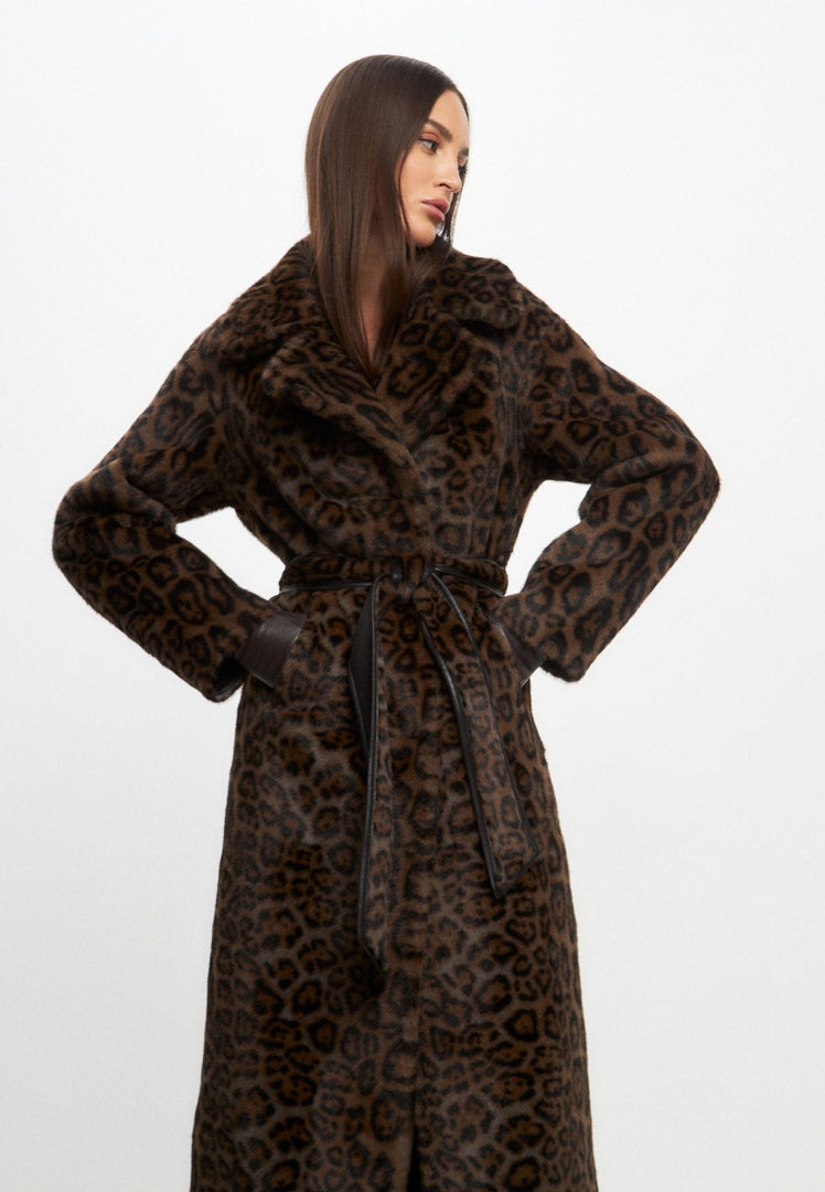 A woman wearing a reversible faux fur coat styled as a long winter outerwear jacket, showcasing the versatility and warmth of faux fur coat styling.