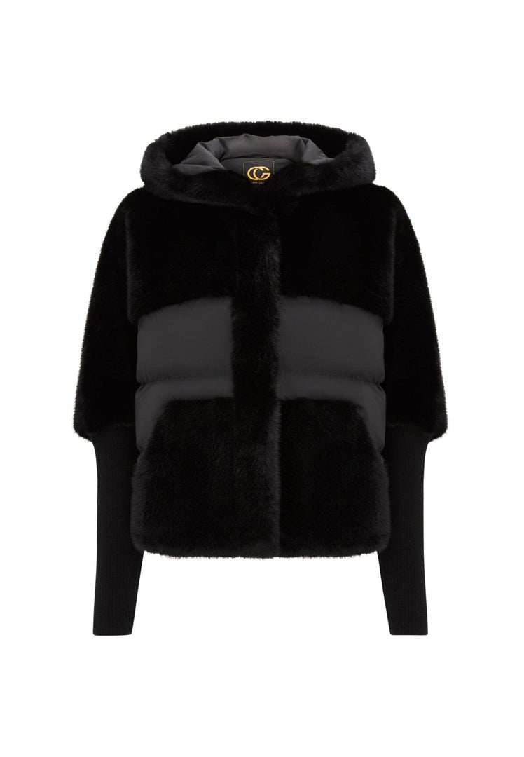 A stylish woman wearing an oversized black faux fur jacket, showcasing trendy women's fur jackets including plus size fur coat options.