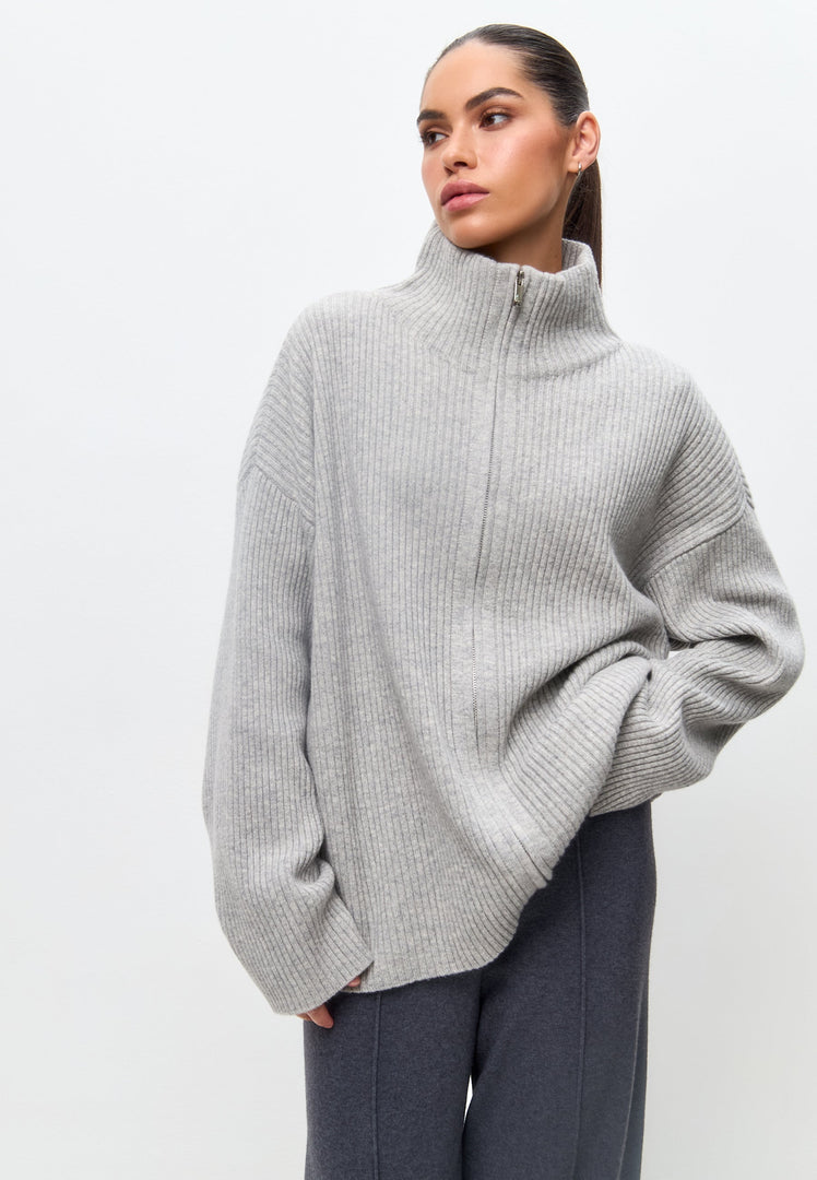A stylish zip-up merino wool sweater in elegant gray, perfect for women who appreciate designer knitwear.