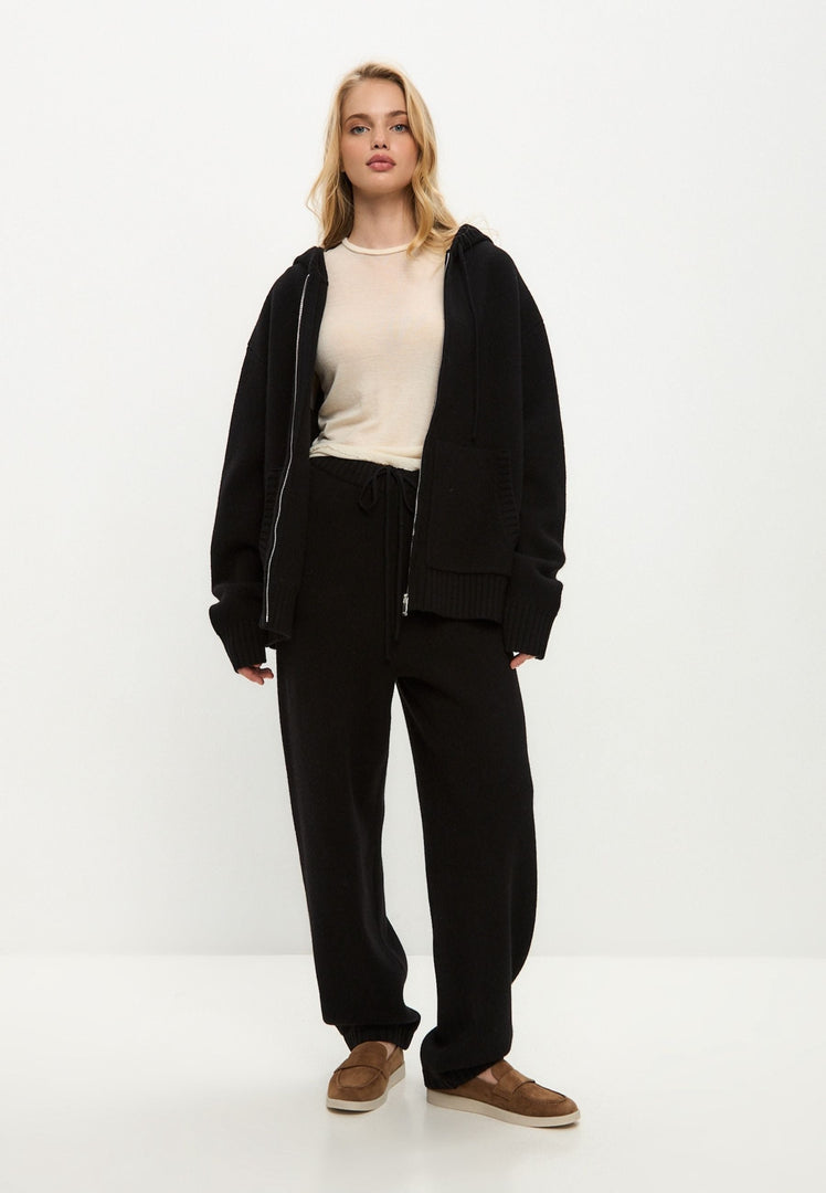 A cozy black Merino wool hooded cardigan, perfect for staying warm in style as a Penelope black cardigan costume.