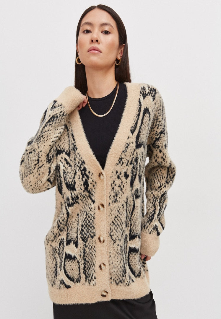 A woman wearing a cozy chunky knitwear cardigan, a perfect oversized choice for winter comfort.
