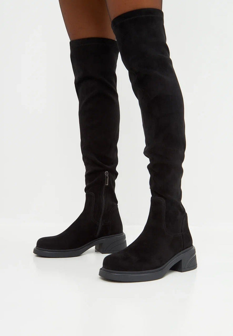 A pair of trendy over-the-knee suede boots, perfect for adding a chic flair to any outfit. Fashion boots for women's footwear lovers.