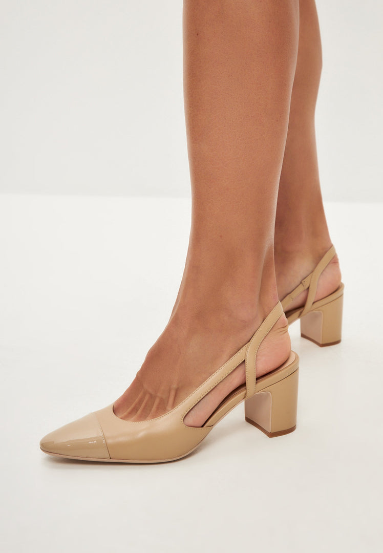 A stylish pair of beige slingback block heel pumps featuring delicate jasmine details, perfect for women's shoe collections.