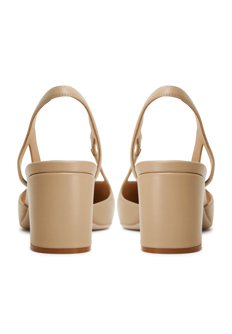 Beige suede pumps with slingback block heels, featuring intricate jasmine detailing, perfect for chic women's shoe collection.
