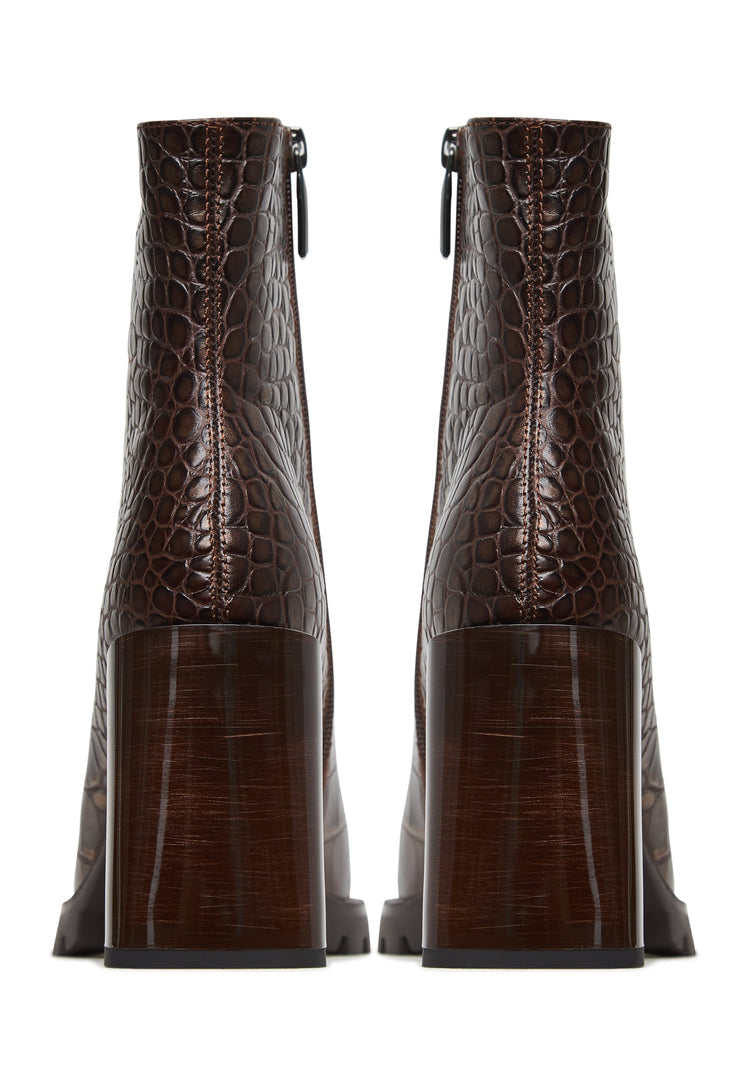 A stylish pair of women's brown block heel boots with crocodile textured print, known as Croc block heel boots or Helen brown boots.