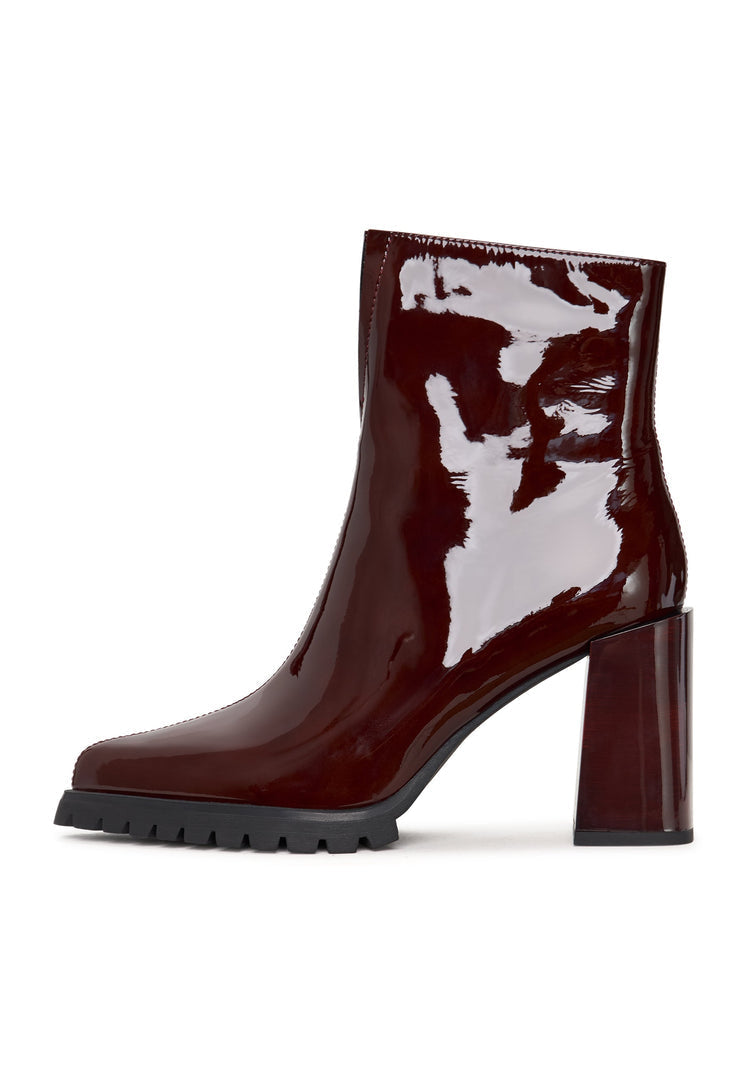 A stylish pair of red block heel women's boots, known as Helen boots, a must-have in fashion footwear trends.