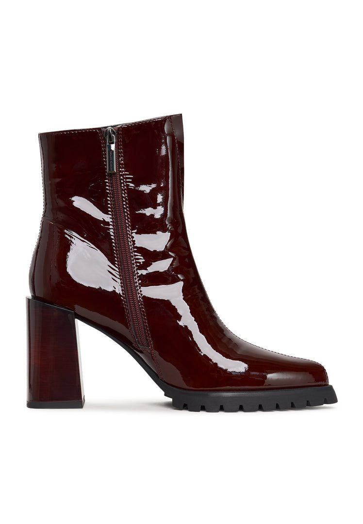 A stylish pair of women's block heel red boots, known as Helen boots, a must-have fashion footwear item.