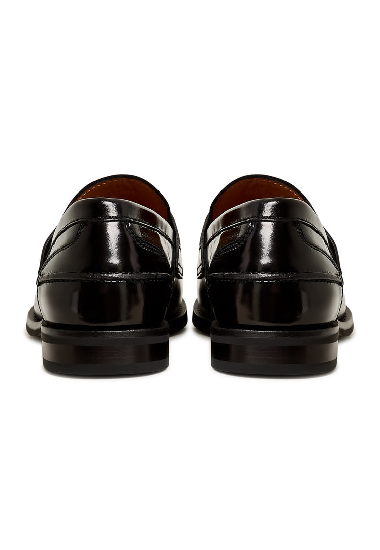 A chic pair of black leather block heeled loafers, the Dinara black shoes, perfect for any woman's wardrobe with their chunky heel design.
