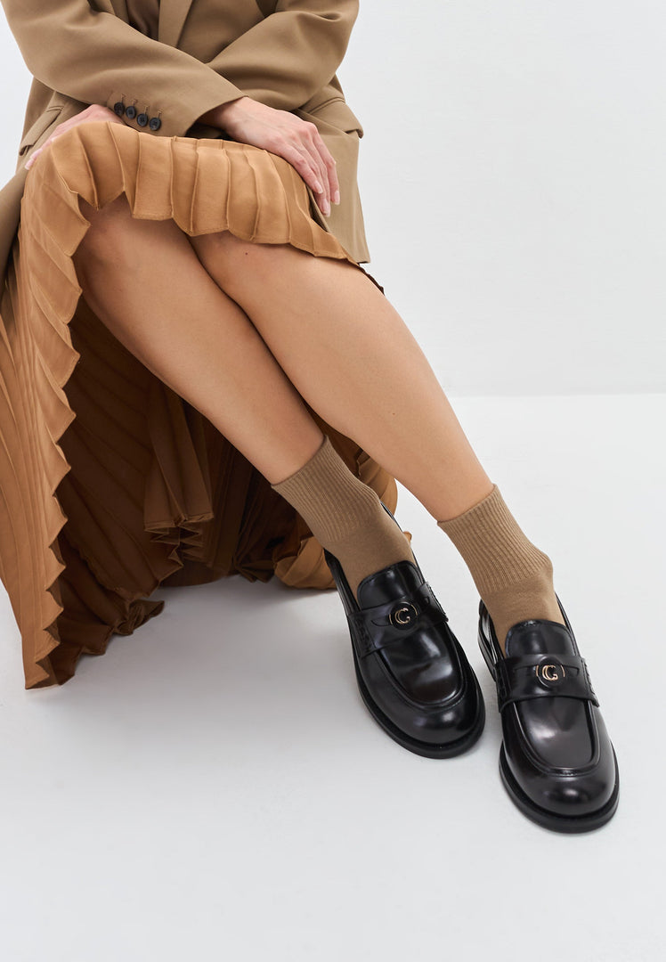 A stylish pair of women's black leather block heeled loafers, also known as Dinara black shoes, featuring a chunky heel design.