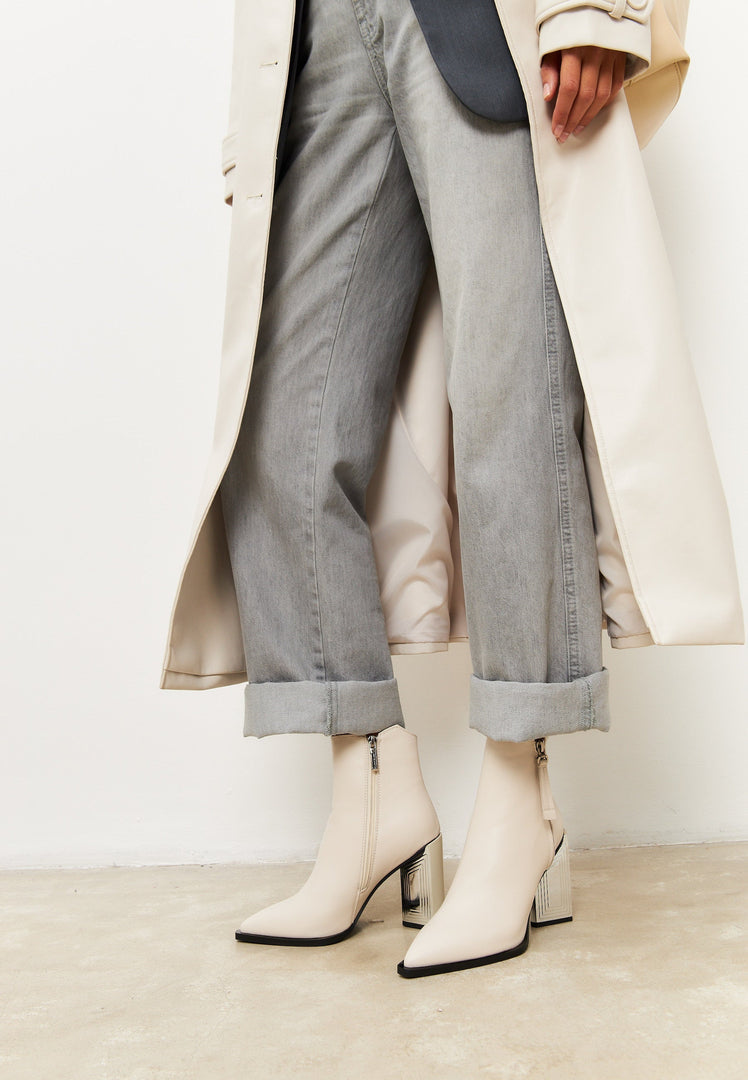 A stylish pair of designer leather ankle boots in classic beige, perfect for women's fashion footwear.
