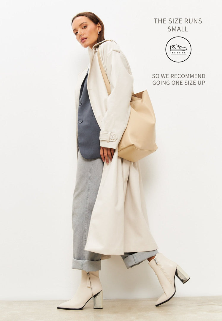 A stylish pair of designer ankle boots in classic beige, perfect women's footwear for any fashion-forward look.