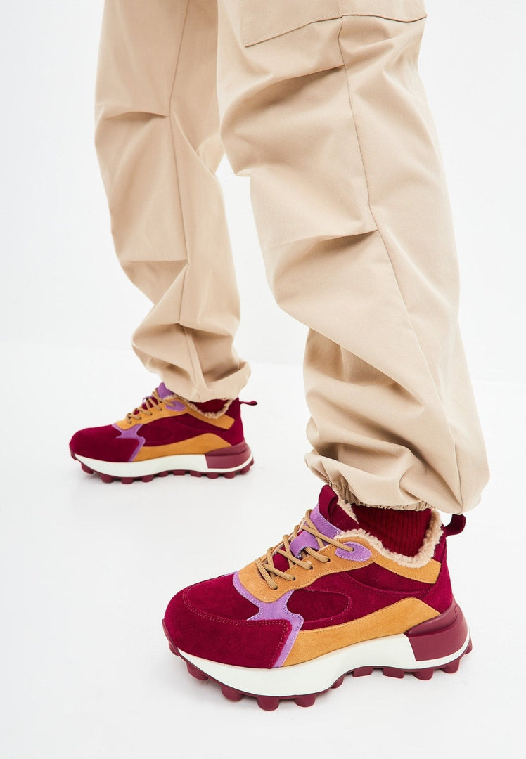 A trendy pair of Bordeaux women's platform sneakers with a chunky heel for a fashionable and comfortable look.