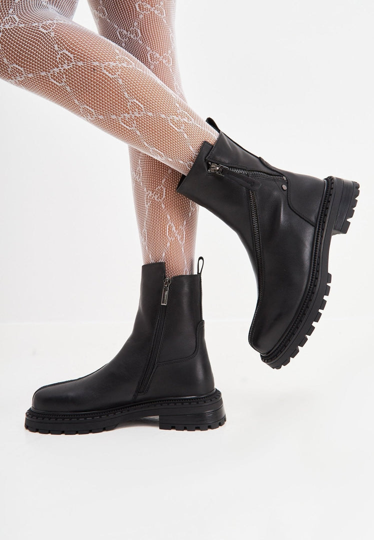 A stylish pair of black leather platform ankle boots with high heels for women.