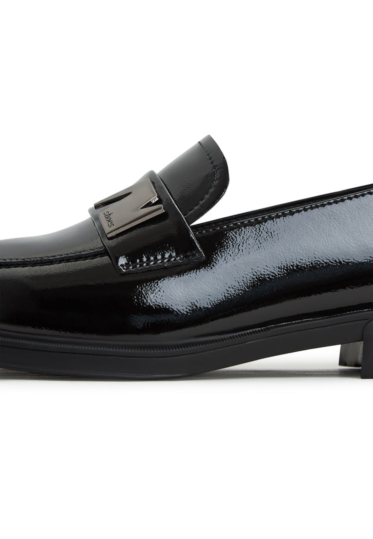 A stylish pair of black block heel loafers for women, a perfect combination of fashion and comfort.