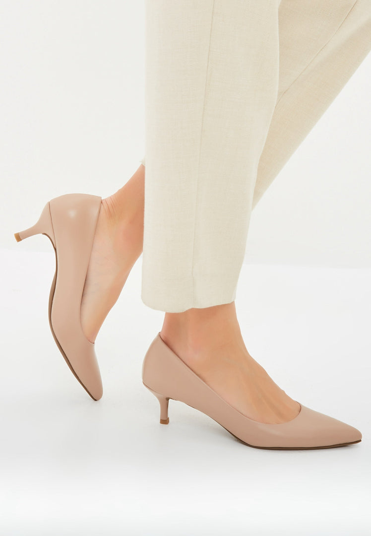 A pair of elegant pumps in luxe beige footwear, featuring designer heels and fashionable stilettos.