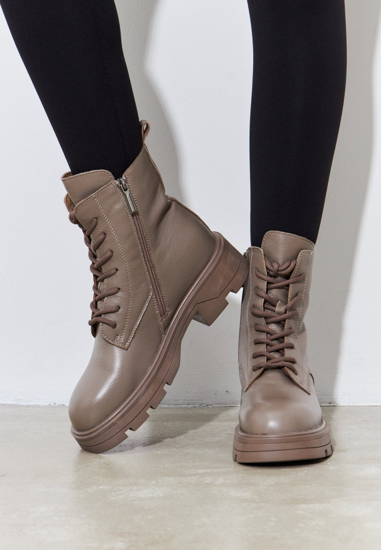 A stylish pair of women's casual lace-up ankle boots in brown, the perfect fashion footwear for any outfit.