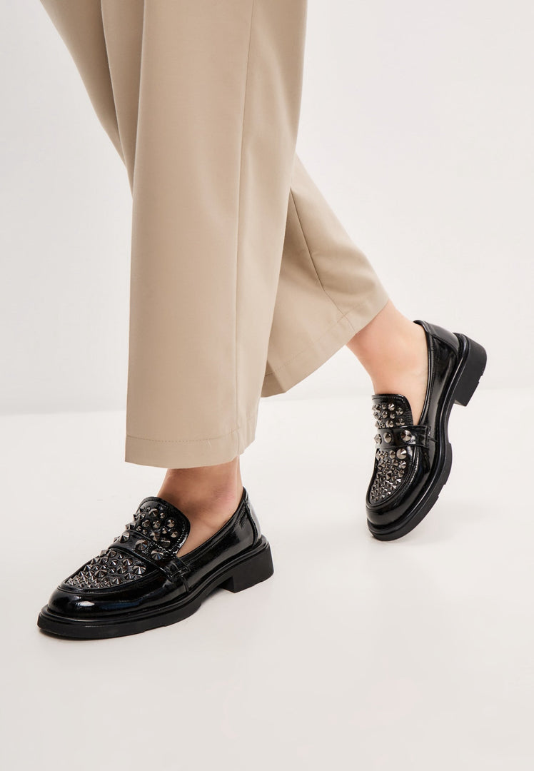 A pair of stylish black leather loafers, the rockstar-inspired men's fashion footwear.