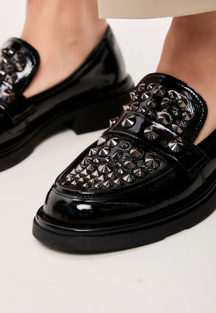 A pair of stylish black leather loafers, perfect for the rockstar-inspired man's fashion footwear.