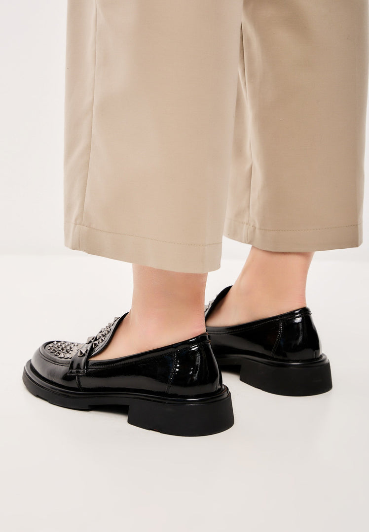 A pair of stylish rockstar-inspired black leather loafers, perfect for men's fashion footwear.