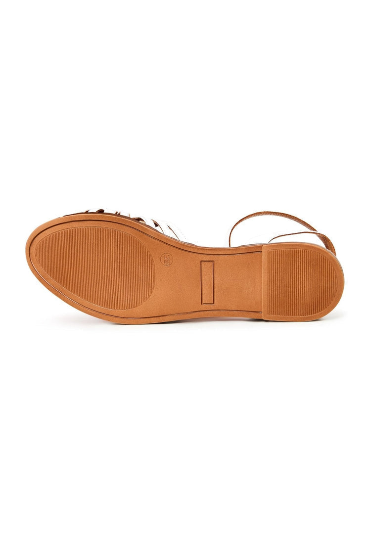A stylish pair of white leather flat sandals for women, perfect for adding a touch of elegance to any outfit.