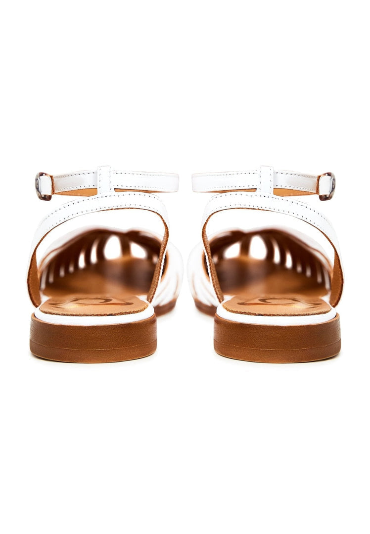 A pair of stylish white leather flat sandals for women, perfect for any summertime outfit.