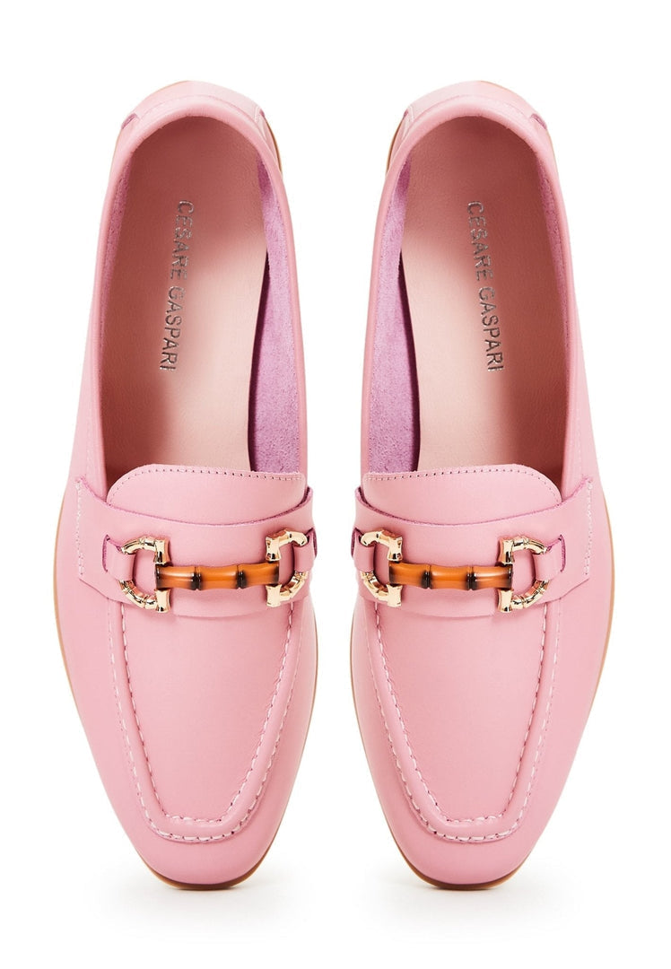 A stylish pair of designer pink leather loafers for women, crafted with high quality materials.