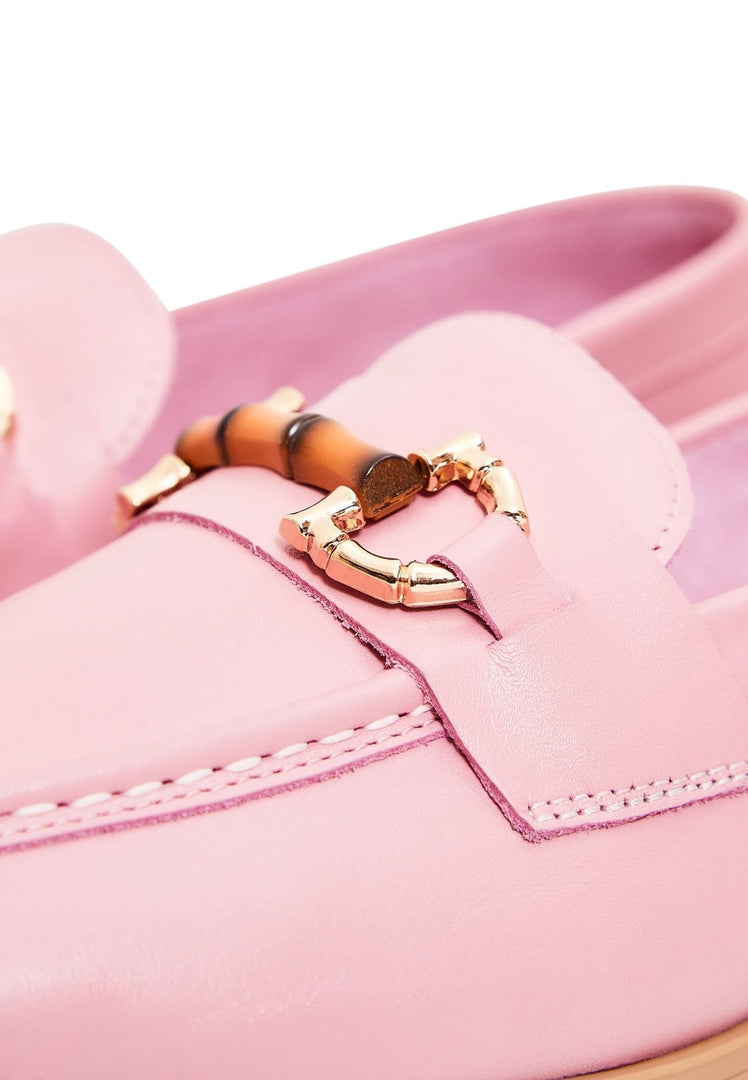 A stylish pair of women's pink leather loafers, the epitome of high quality designer shoes.