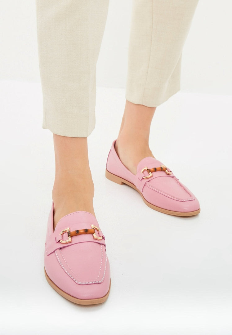 A pair of high quality designer leather loafers in pink, perfect for women.