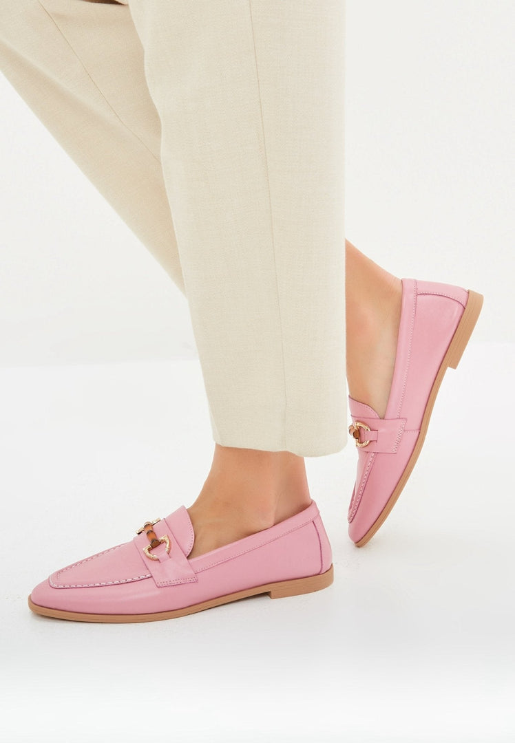 A stylish pair of high-quality pink leather loafers, perfect for women who appreciate designer leather shoes.