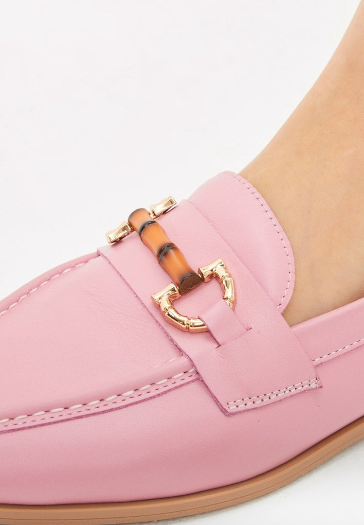 A stylish pair of pink leather loafers, perfect for women who appreciate high quality designer shoes.