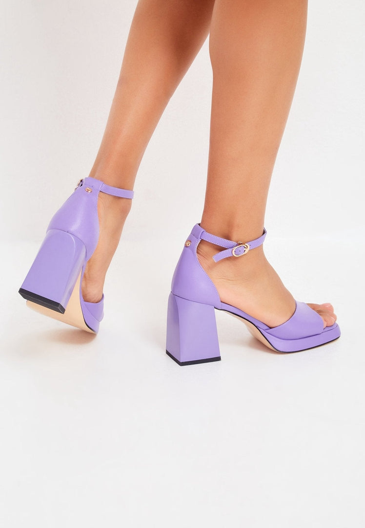 A pair of classic open toe high heel sandals in a lovely lilac color, perfect for stepping up your fashion game. Buy these lilac high heel sandals online for a touch of elegance.