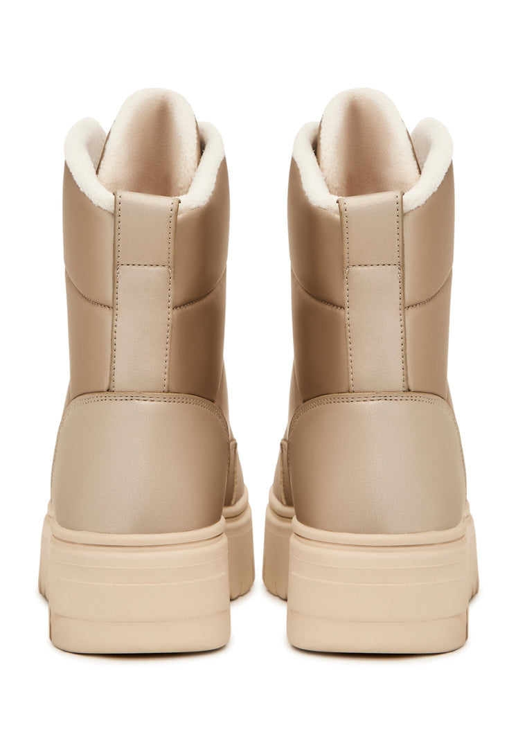 A stylish pair of beige winter boots, perfect for the cold weather - elegant and practical snow boots.