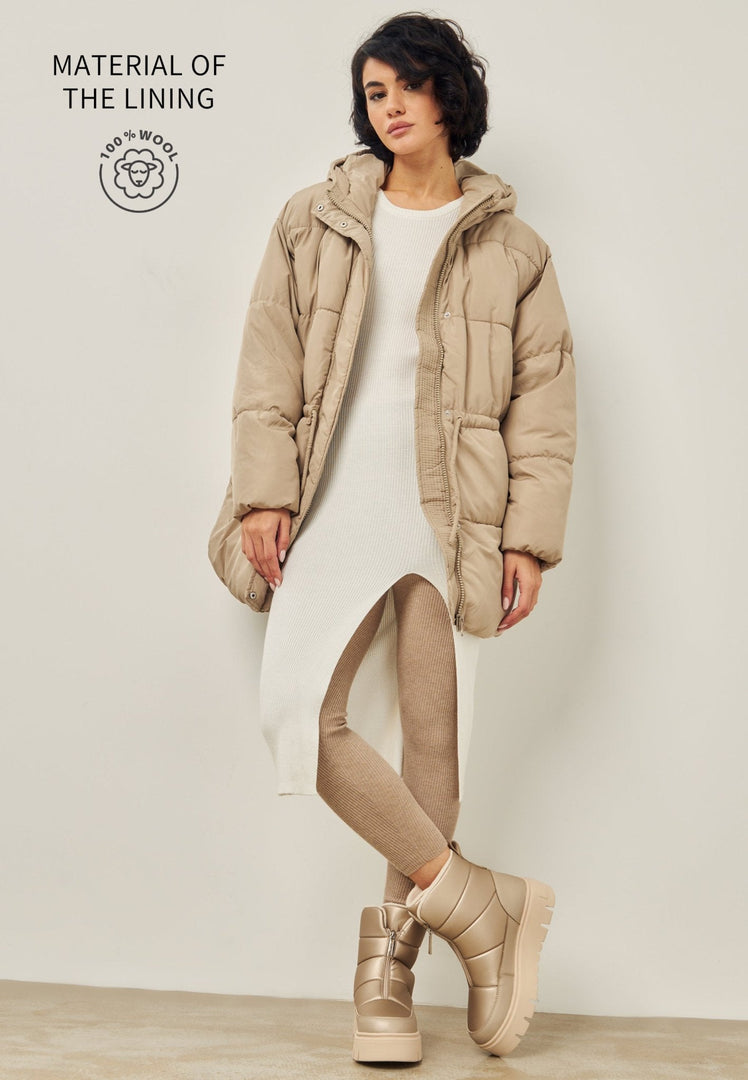 A pair of stylish beige winter boots, perfect for cold weather, featuring elegant design suitable for snowy days.