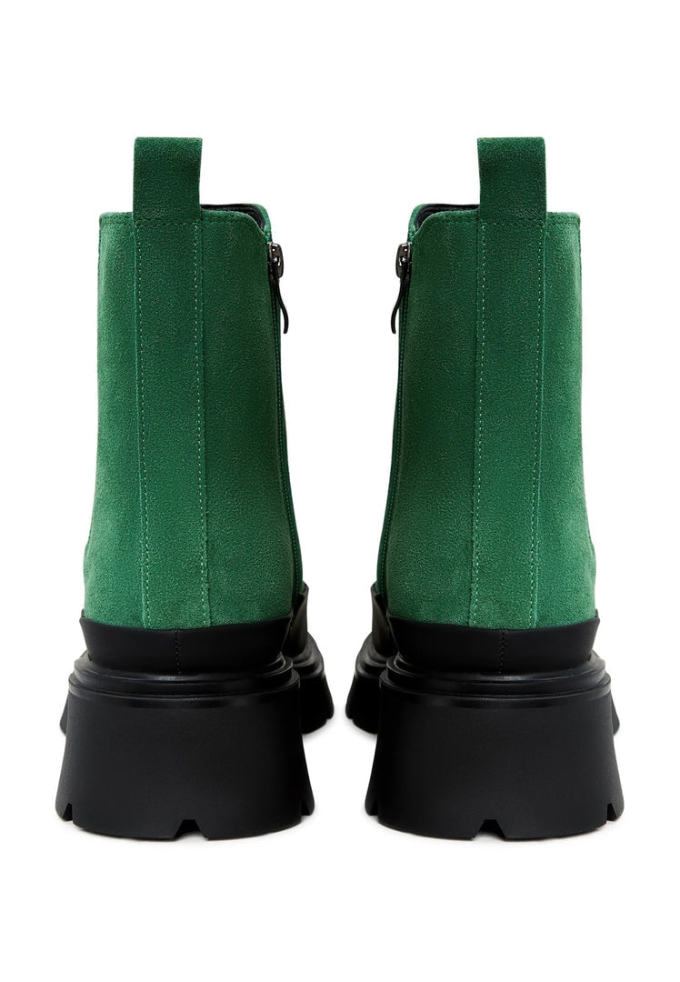 A pair of stylish green urban platform ankle boots for women, the perfect fashionable footwear choice.