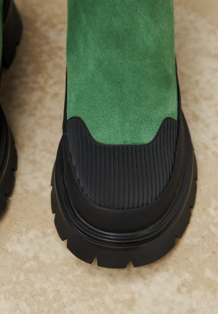 A pair of stylish green urban platform ankle boots for women, perfect for fashionable urban footwear.