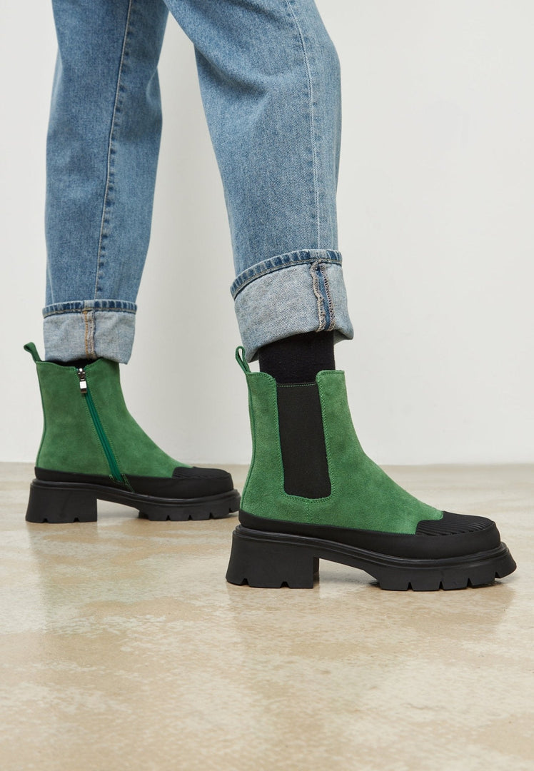 A pair of stylish green urban platform ankle boots for women, the perfect fashionable footwear choice.