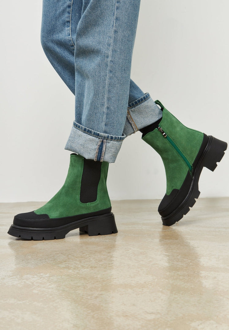 A stylish pair of urban platform ankle boots in trendy green, perfect for fashionable women looking for chic and edgy footwear.